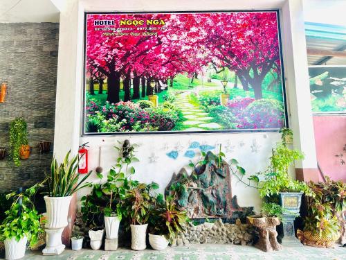 a large picture of a flower garden on a wall with plants at Ngọc Nga Hotel in Phan Rang–Tháp Chàm