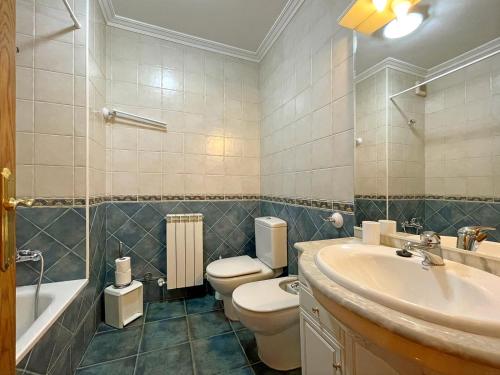 a bathroom with a toilet and a sink and a tub at Casar Rural Lazkua I-II in Eraul