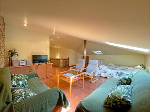 a living room with two couches and a tv at Casar Rural Lazkua I-II in Eraul