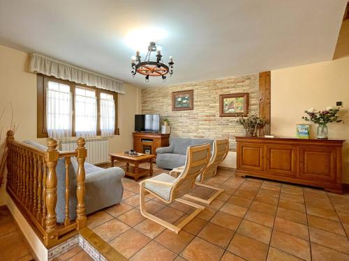 a living room with a couch and a chair at Casar Rural Lazkua I-II in Eraul