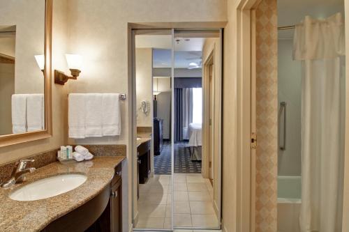 a bathroom with a sink and a walk in shower at Homewood Suites by Hilton Toronto-Oakville in Oakville