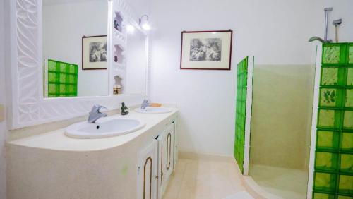 a white bathroom with a sink and a shower at Great Rustic Escape 3 bedroom Villa, Casuarina, Malindi in Malindi