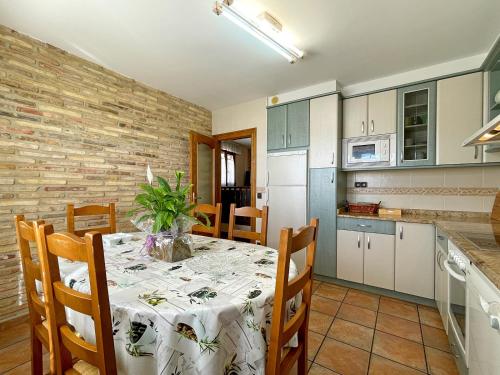 a dining room with a table and a kitchen at Casar Rural Lazkua I-II in Eraul