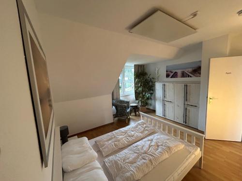 a bedroom with a bed and a living room at Beach Club Fehmarn 9249 in Fehmarn