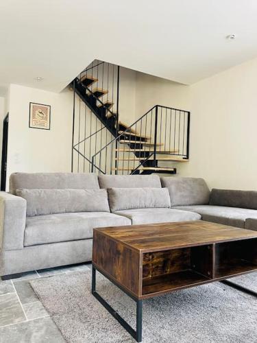 a living room with a couch and a coffee table at Villa* Piscine* Vue sur château de Beynac in Castelnaud La Chapelle