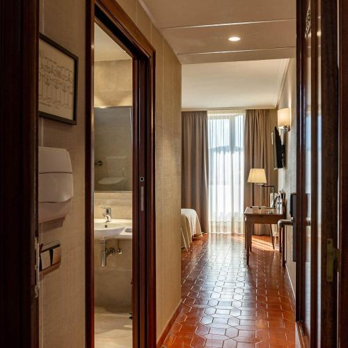 a hotel room with a bathroom with a sink at HOSTAL DOÑA JUANA in Ágreda