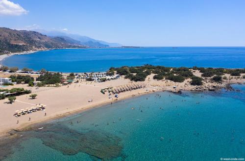 an aerial view of a beach with people in the water at Mear Holiday Homes - Cretan Summer Getaways in Kountoura Selino