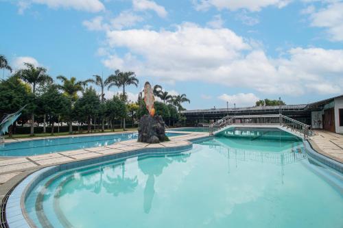 a large pool with a statue in the middle at Grand Nirwana Resort Lembang in Tangkubanperahu