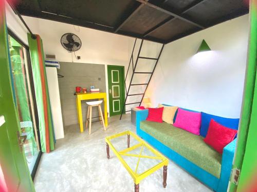 a living room with a couch and a table at Randoni Villa in Raddoluwa