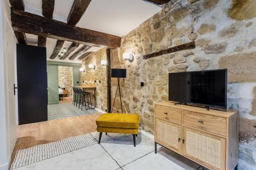 - un salon avec une télévision sur une commode en bois dans l'établissement Typical Parisian Apartment in Le Marais#4 pers, à Paris