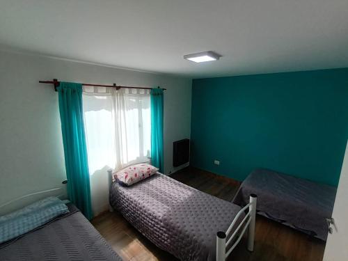 - une chambre avec 2 lits et une fenêtre dans l'établissement Lo de fernando 5, à Río Gallegos