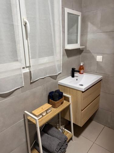 uma casa de banho com um lavatório e um espelho em Cosy em Ivry-sur-Seine