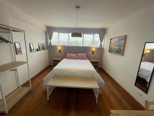 a bedroom with a large bed with a pink pillow at Illa B&B in Cusco