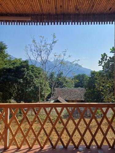 a wooden fence with a view of a mountain at Hill House in Mai Chau