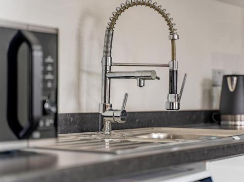 a kitchen sink with a faucet and a sink at Birmingham Apt-Sleeps 4-Walk to City Centre-Pets in Birmingham