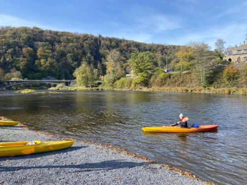 a man is in a kayak on a river at Le Doux Refuge de Bouillon in Corbion