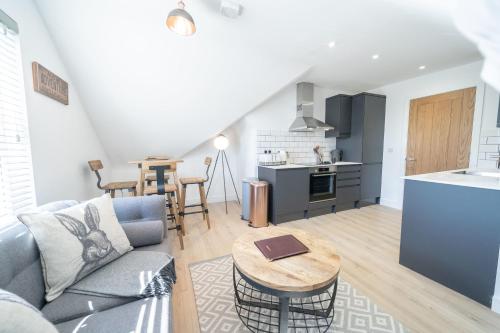 a living room with a couch and a table at 4 Ashbrook Windmill in Oxford