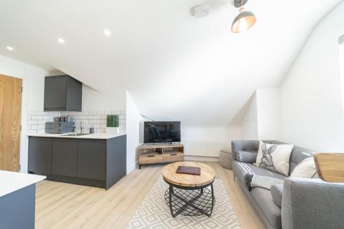 a living room with a couch and a table at 4 Ashbrook Windmill in Oxford