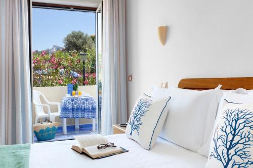 a bedroom with a bed with a view of a patio at Hotel Piccolo Paradiso in Massa Lubrense