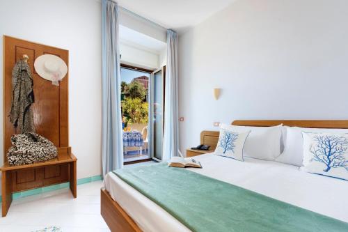 a bedroom with a bed and a large window at Hotel Piccolo Paradiso in Massa Lubrense