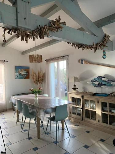 - une cuisine avec une table à manger et des chaises dans l'établissement Maison de vacances : Bord de mer, à Saint-Pierre-dʼOléron