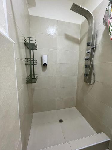 a bathroom with a shower with a sink and a roll gmaxwell gmaxwell gmaxwell at Illa B&B in Cusco