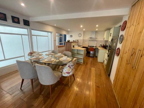 a kitchen and dining room with a table and chairs at Illa B&B in Cusco