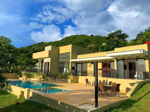 a house with a patio and a swimming pool at Mountain View Anapoima in Anapoima