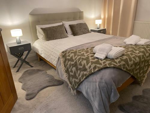 a bedroom with a large bed with two pillows on it at Standard Villa in London