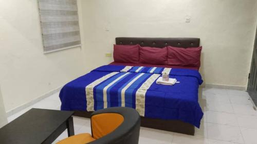 JEFFOSA Hotel & Suites في لاغوس: غرفة نوم بسرير وطاولة وكرسي