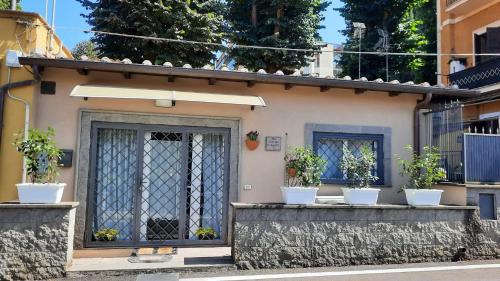a building with four potted plants on a ledge at Noralù House in Grottaferrata