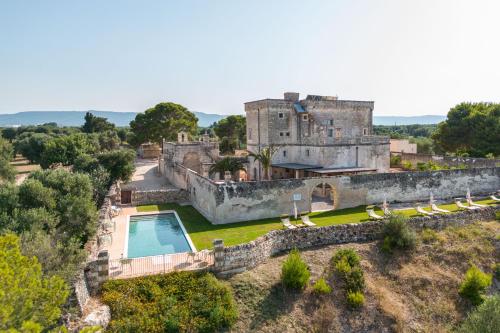 an aerial view of a castle with a swimming pool at Masseria Torrelonga in Fasano