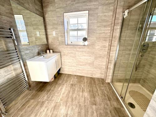 a bathroom with a sink and a shower at Cosy town centre apartment in Bedford