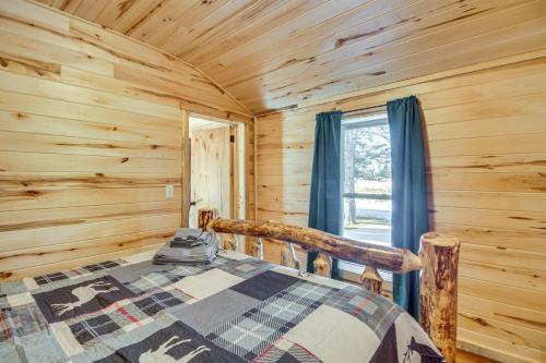 ein Schlafzimmer mit einem Bett in einem Blockhaus in der Unterkunft Pet-Friendly Minnesota Abode Near Golfing and Hiking 