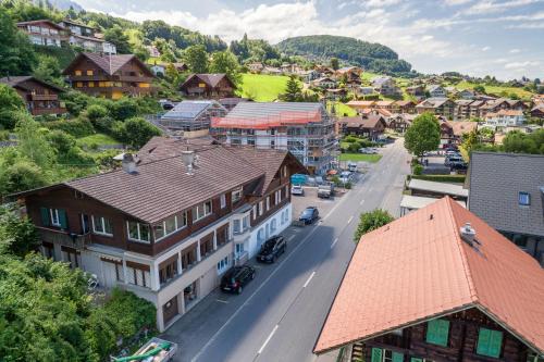 an aerial view of a town with houses and a street at Bijou Lake Side - mit Seesicht und Privatstrand in Faulensee