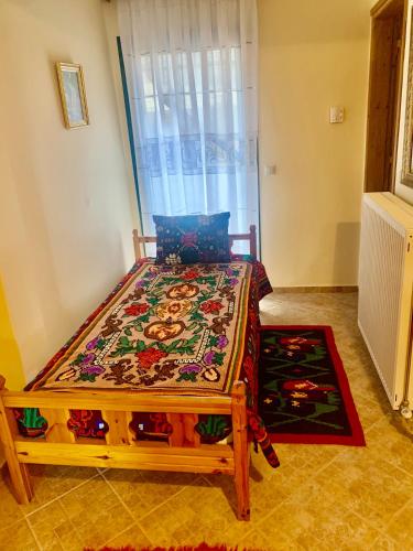 a bed sitting in a room with a window at Lake Stories in Koutsodímos