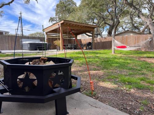 a fire pit in a yard with a tent at Knot Bay Haven, Dog Friendly, Hot Tub, Fenced yard, Patio and Grill, 3 BR in Rockport