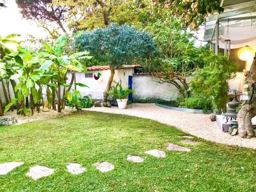 a garden with rocks in the grass at Casa dell'artista in Casal Palocco