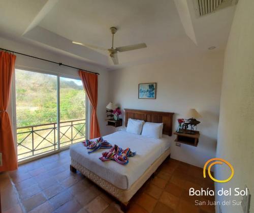 a bedroom with a bed with flip flops on it at Bahia Del Sol Villas & Condominiums in San Juan del Sur