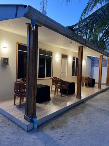 a patio with benches and tables on a house at INFINITE LAGOON in Mandhoo
