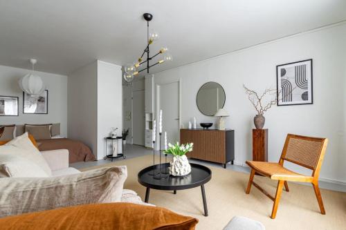 a living room with a couch and a table at Stylish Studio Haven Ideal for Four Guests in Stockholm