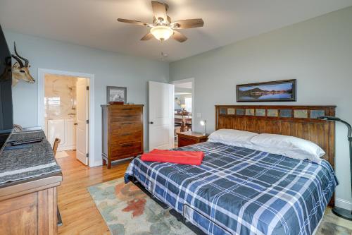 a bedroom with a bed and a ceiling fan at Yankton Vacation Home with Hot Tub and River Views in Yankton