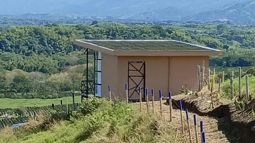 a small building on the side of a hill at Finca Maratón Alto in Calarcá