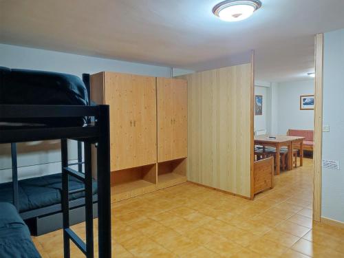 a room with a bunk bed and a dining room at Apartamentos Midi 3000 in Formigal
