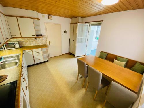 a kitchen with a table and chairs in a room at Mountain Majesty Residences in Matten