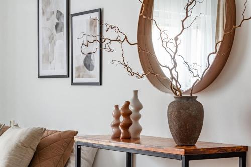 a living room with a table and a mirror at Cheap stay on hip Södermalm - construction work in Stockholm