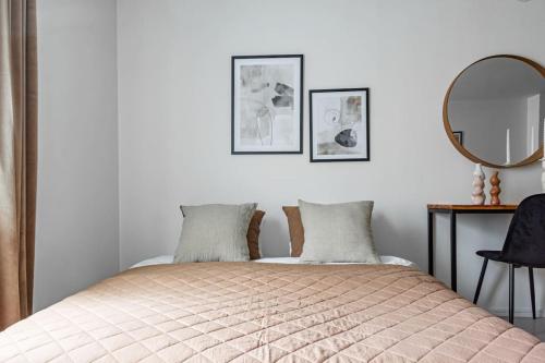 a bedroom with a bed with two pillows and a mirror at Cheap stay on hip Södermalm - construction work in Stockholm