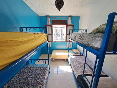 a room with two bunk beds and a window at Moroccan Family House in Agadir