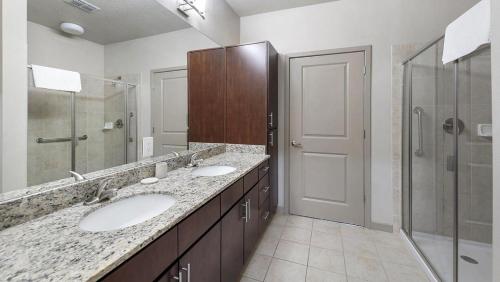 a bathroom with two sinks and a shower at Landing Modern Apartment with Amazing Amenities (ID9660X22) in Orlando