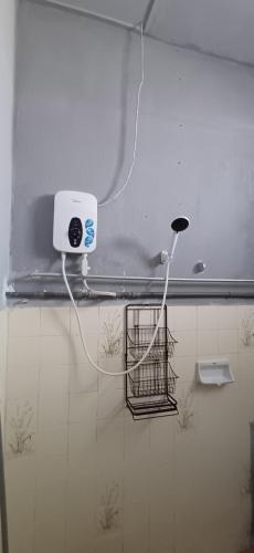 a white light on a wall in a bathroom at Cozy Nature Homestay - Free Wifi Disney Hotstar ADS in Nibung Tebal